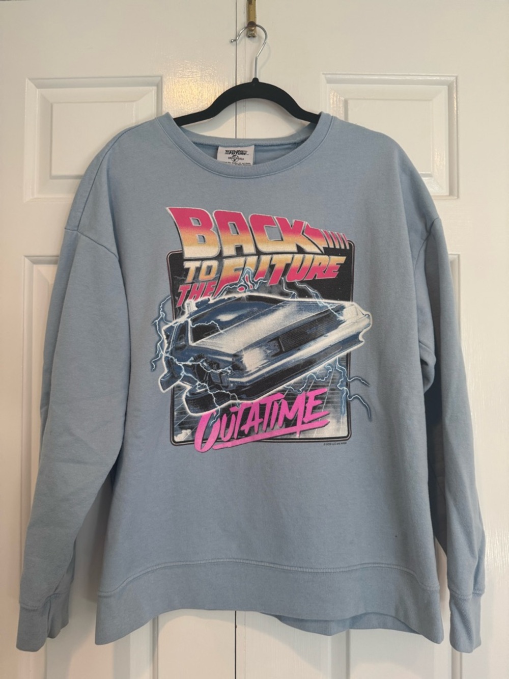 Universal Light Blue Graphic Tee with Pink Accent